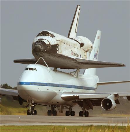 The space shuttle Discovery, riding on the back of a modified Boeing 747, lands at the Kennedy Space Center in Cape Canaveral, Florida, August 21, 2005.